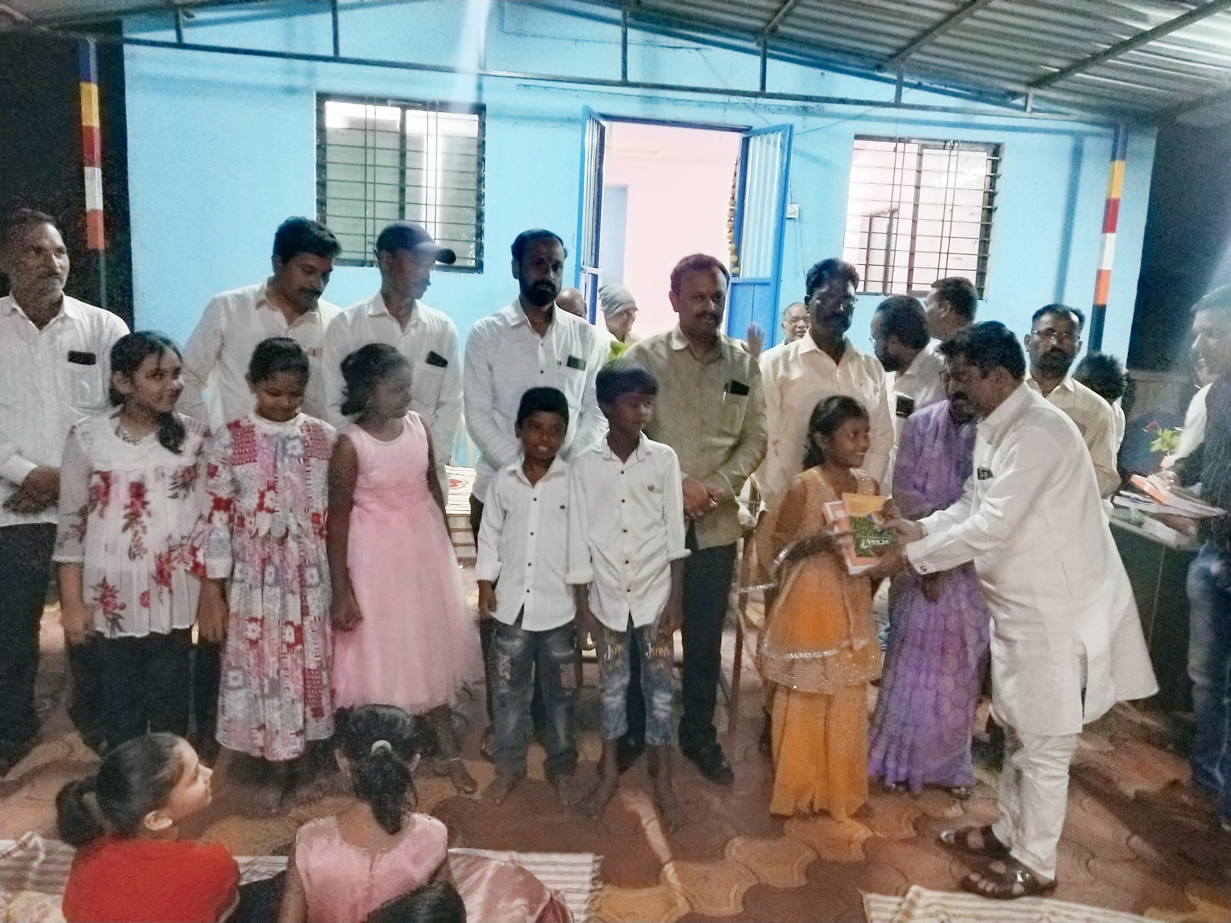 Distribution of educational materials to students by Dr Sujit Minchekar